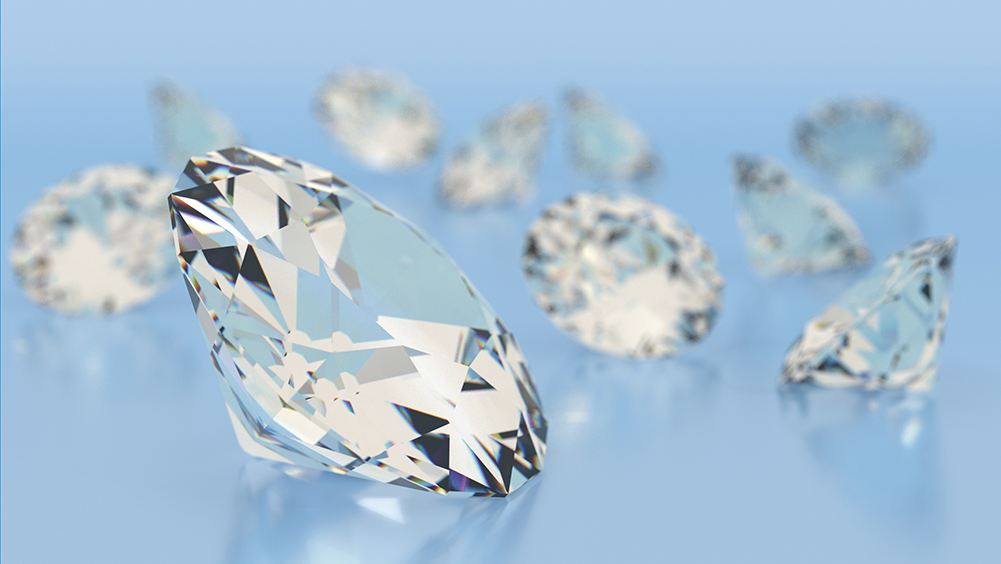 Close-up of brilliant cut diamonds on blue background